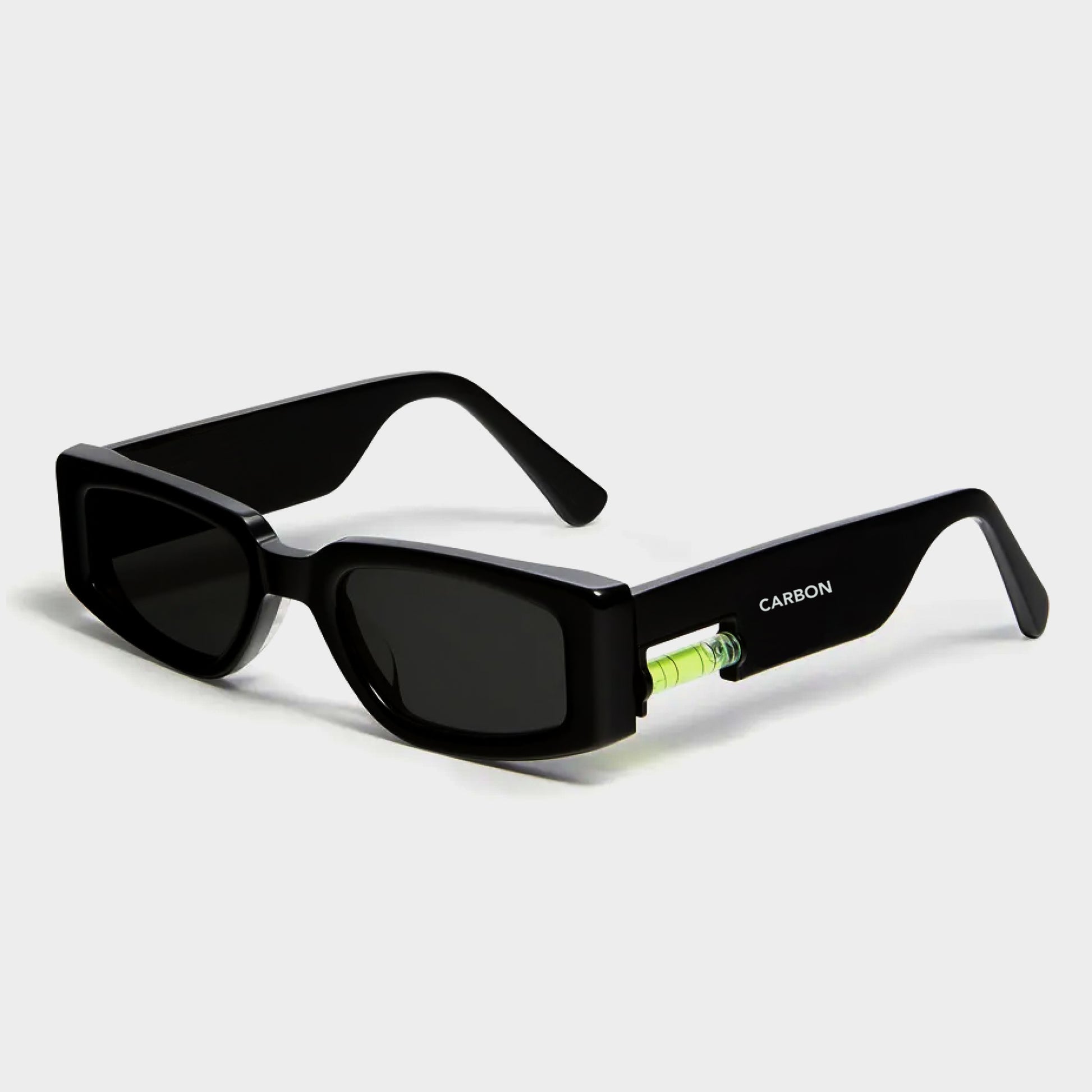 Black sunglasses with a visible brand name on a light gray background