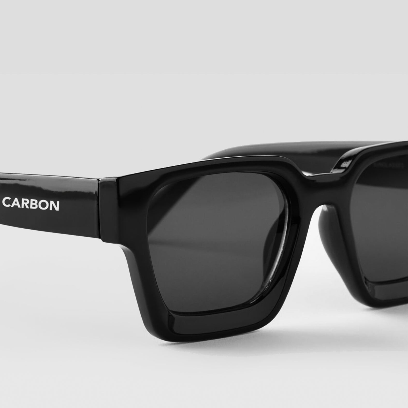 Close-up detail of Carbon NEXUS Black Square Sunglasses frame and lenses