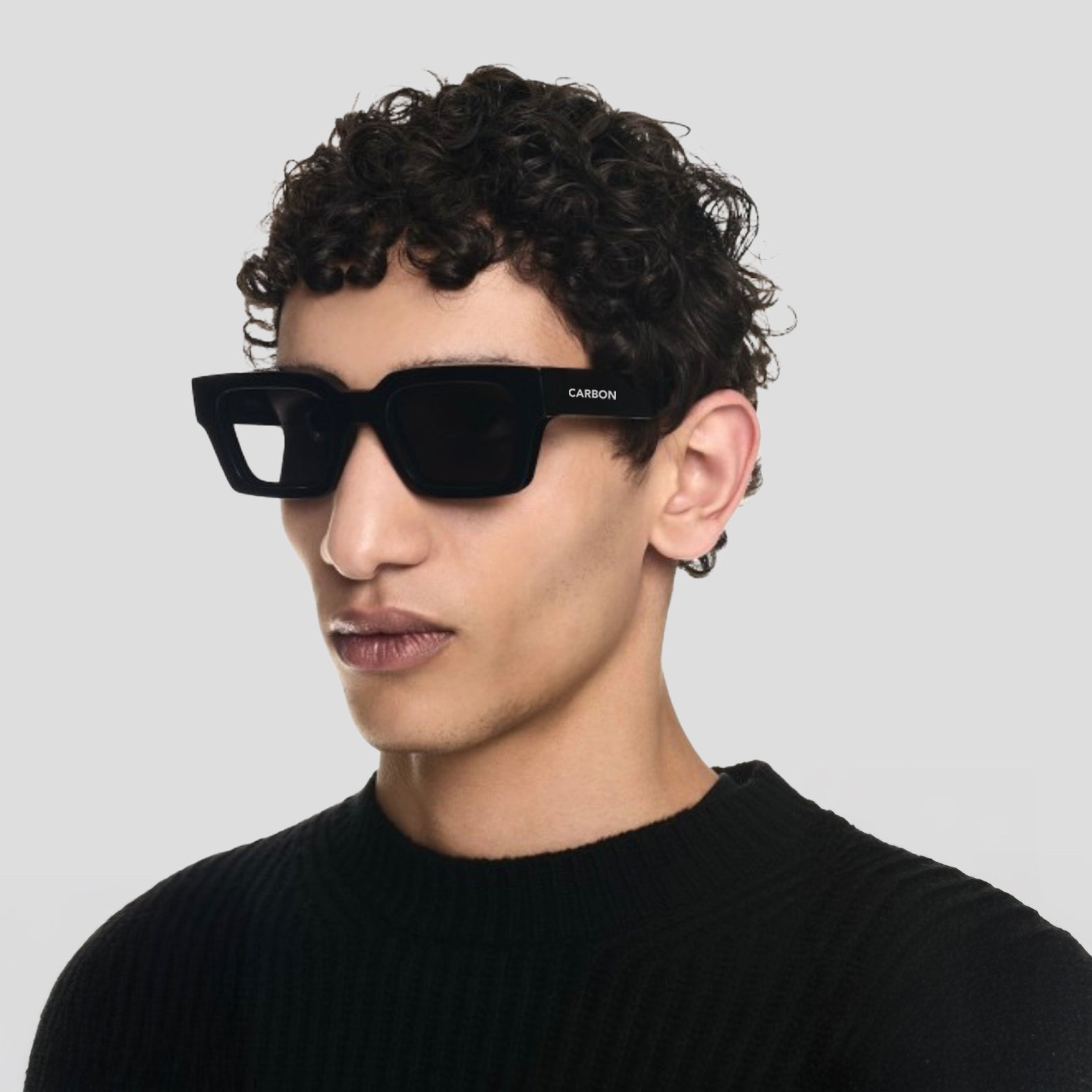 Lifestyle image of person wearing Carbon NEXUS Black Square Sunglasses outdoors