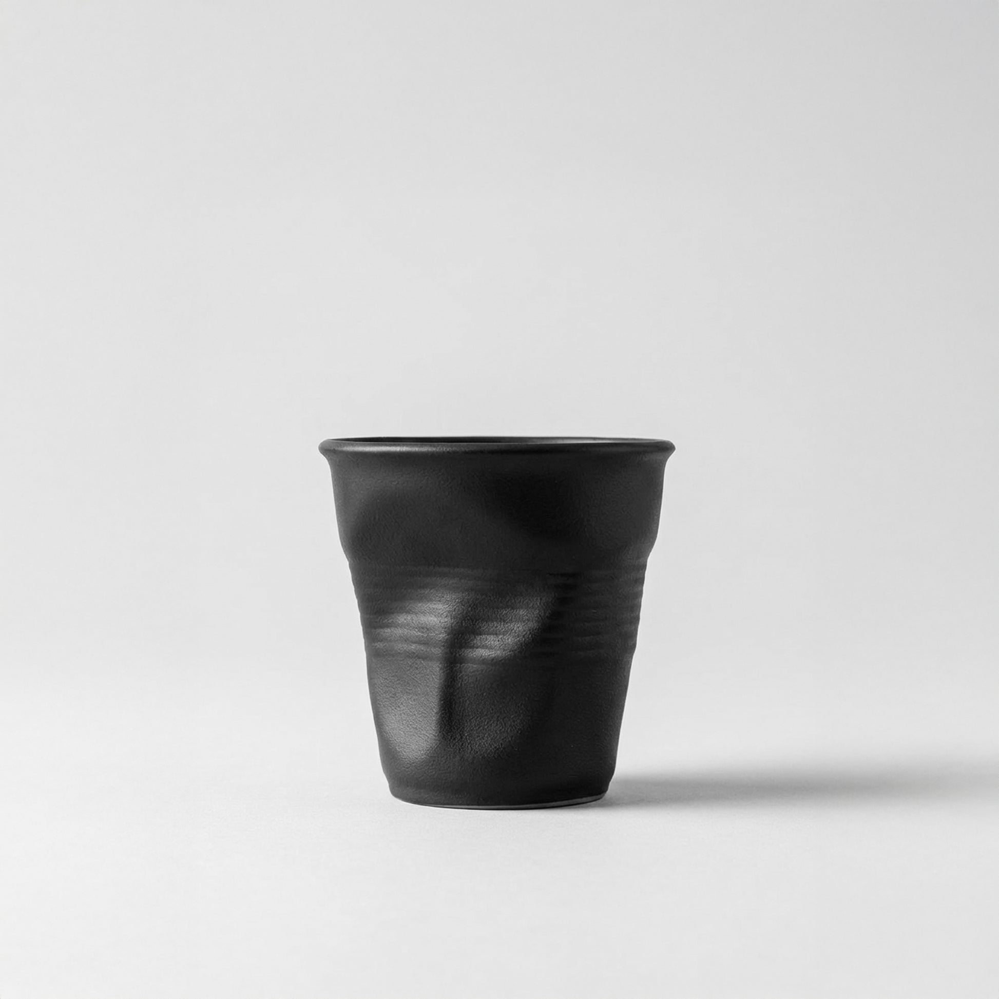 Carbon SCAR black irregular ceramic espresso cup with crushed paper texture, luxury designer espresso cup